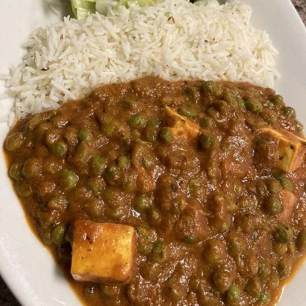 Mutter Paneer, a rich Indian curry with peas and paneer cheese, served with white rice.